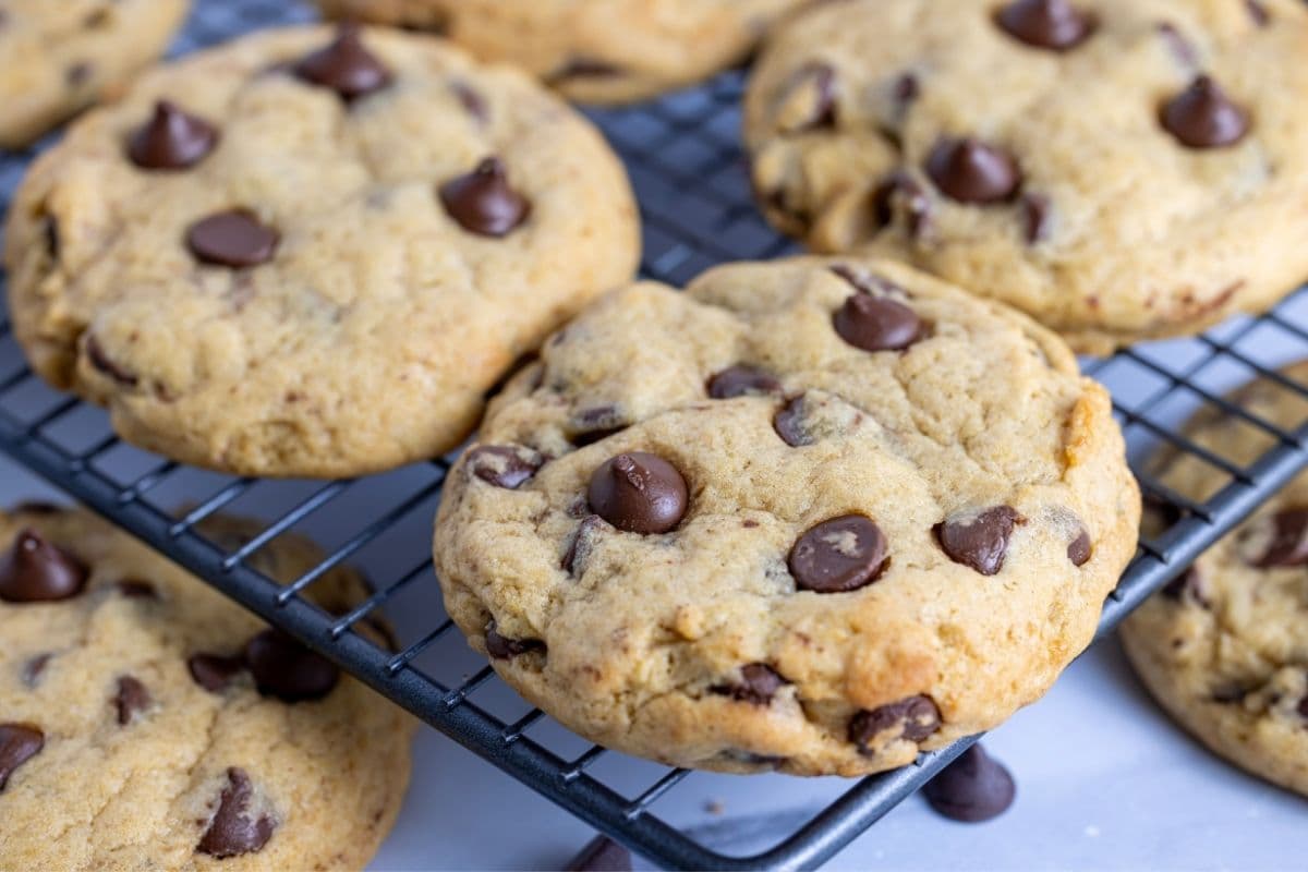 Sourdough chocolate chip cookies cooling on a wire rack.
