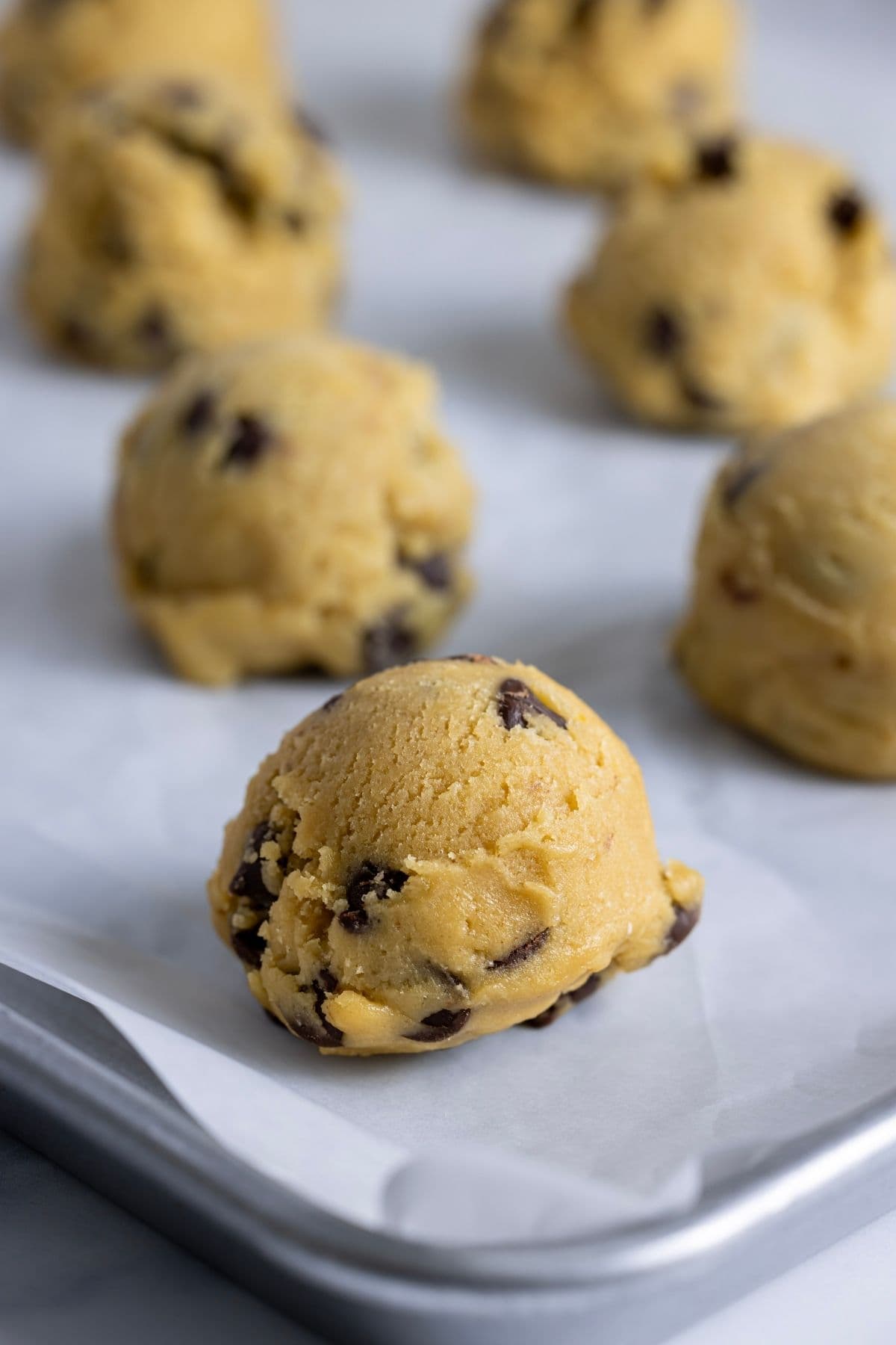 A close up photo of scoops of sourdough discard chocolate chip cookie dough.