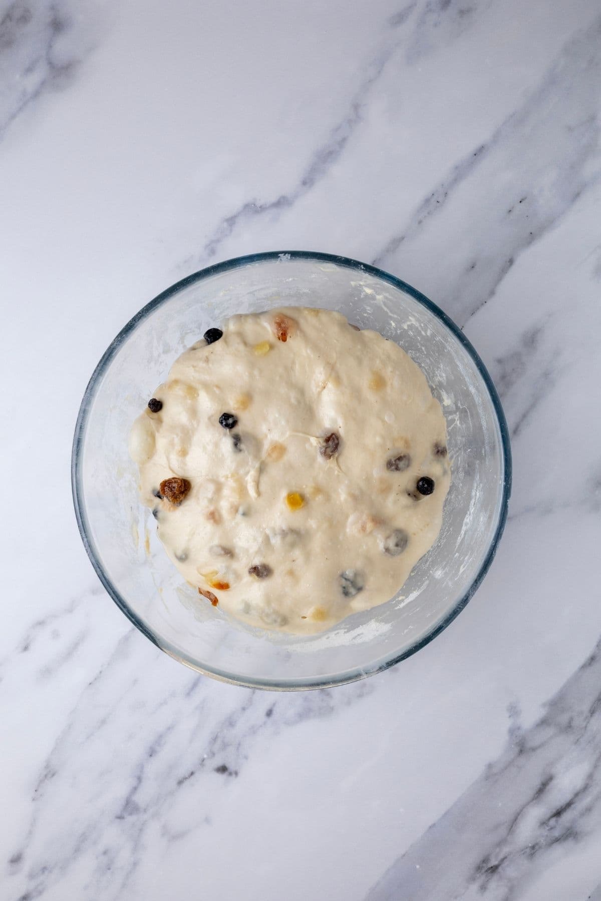 Sourdough fruit loaf in a glass bowl. This is the end of bulk fermentation so the dough has doubled and is marshmallow like in texture.