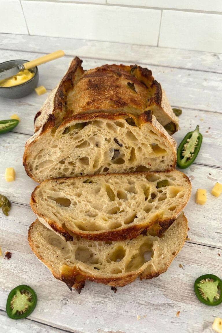 Jalapeno Cheddar sourdough bread that has been sliced open so you can see the open crumb inside.