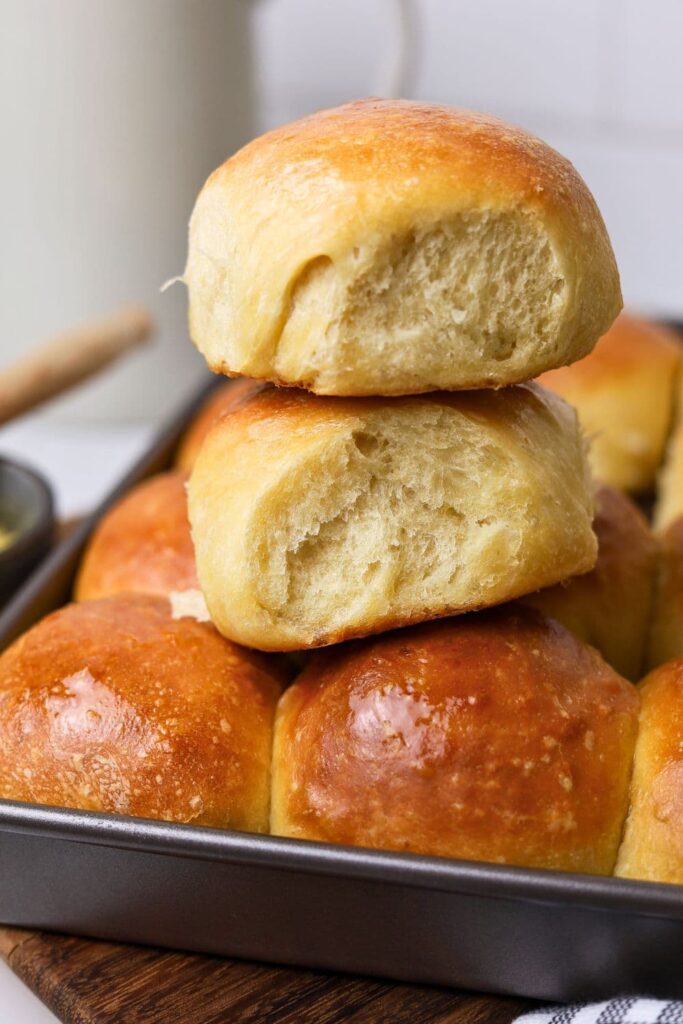 Two sourdough Hawaiian rolls stacked up on top of one another.