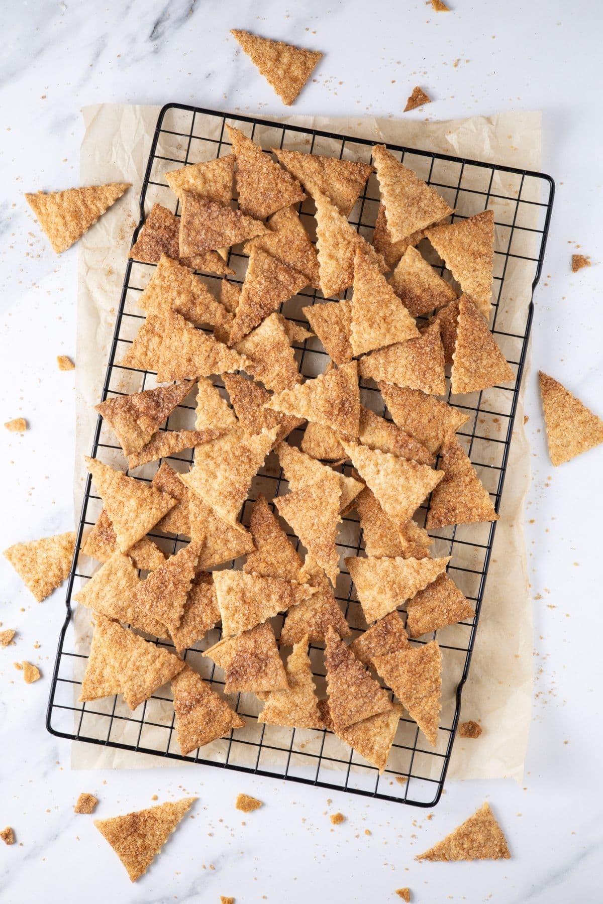 A batch of sourdough cinnamon crackers cooling on a wire rack.