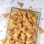A batch of sourdough cinnamon crackers cooling on a wire rack.