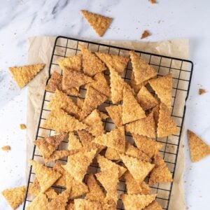 A batch of sourdough cinnamon crackers cooling on a wire rack.