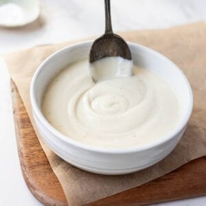Sourdough Bechamel Sauce served in a white bowl with a vintage spoon.