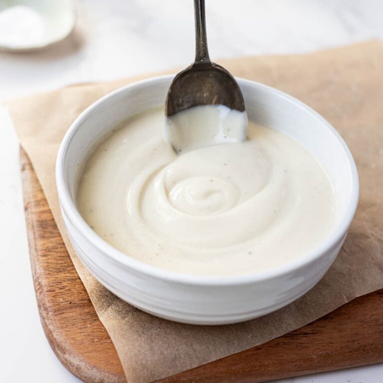 Sourdough Bechamel Sauce served in a white bowl with a vintage spoon.