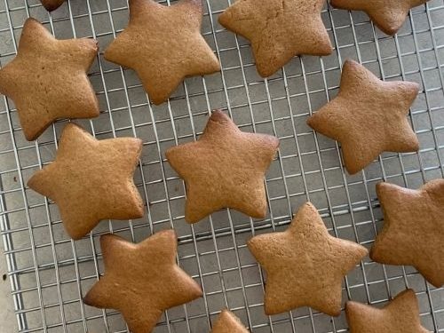 Gingerbread cookies as stars shape for Christmas, on a parchment