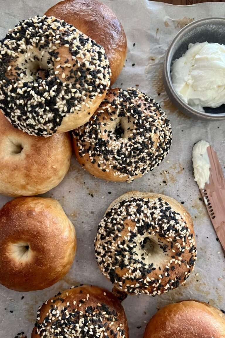 Easy sourdough bagels on tray with cream cheese