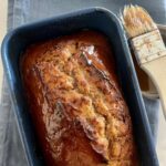 Glazing the banana bread with golden syrup