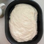 Focaccia dough in a cast iron baking pan