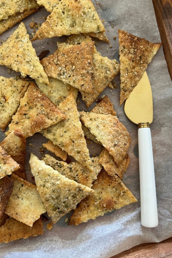Savory Sourdough Vegan Crackers displayed on a tray with a palette knife.