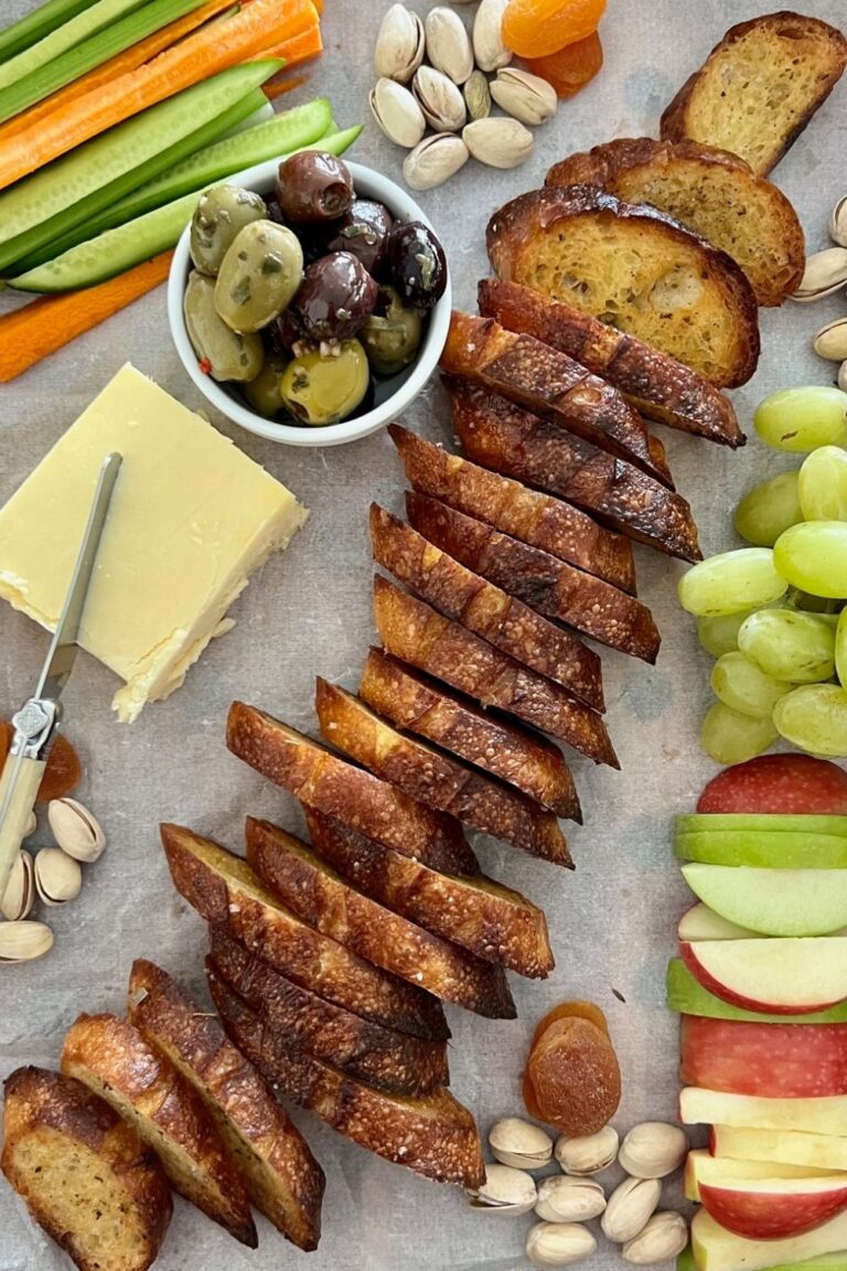 Sourdough crostini are the hero of this cheese platter featuring fresh fruit and vegetables, green tomato relish and dried fruits and nuts.