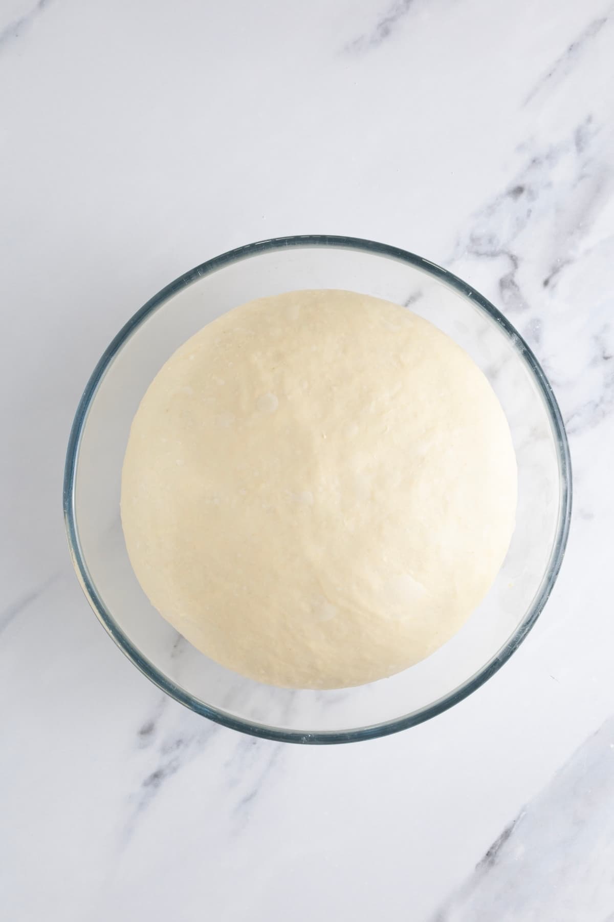 Sourdough discard pizza dough at the end of bulk fermentation.