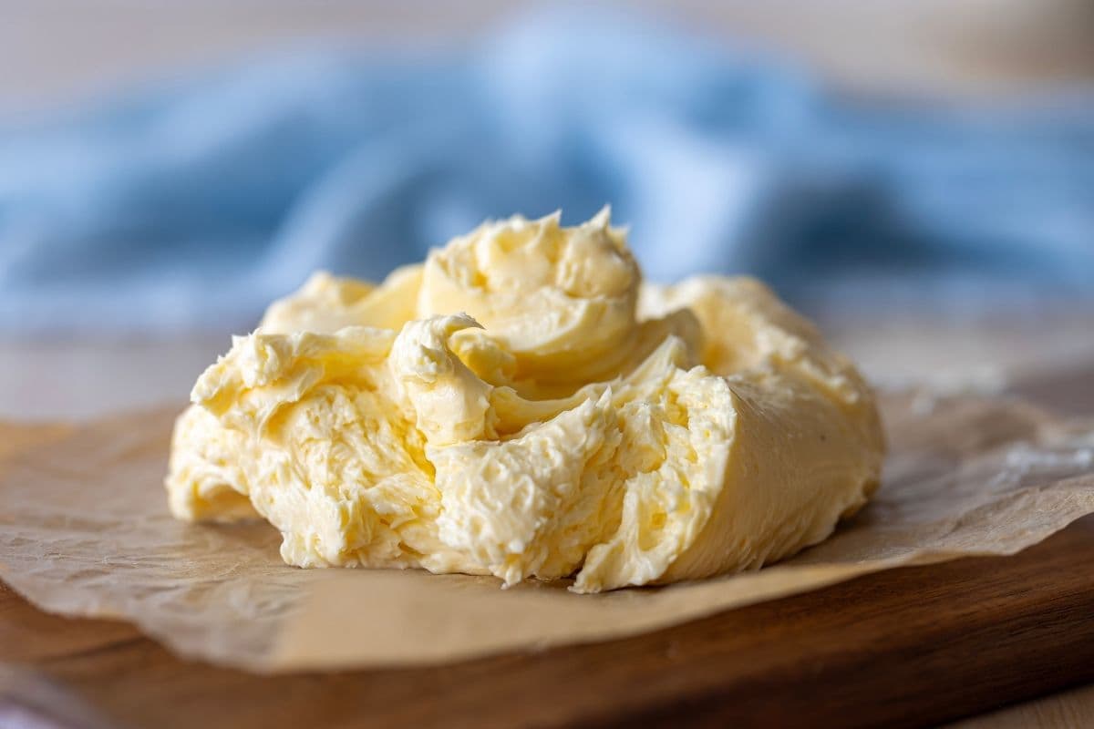 A large swirl of cultured butter spread on a piece of parchment paper.