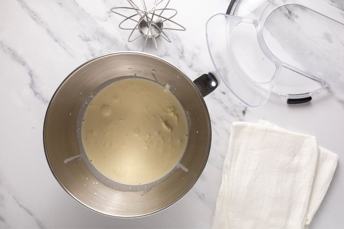A horizontal photo showing the cultured cream sitting inside a stainless steel KitchenAid bowl. You can see that the cultured cream is thick and bubbly from the fermentation.
