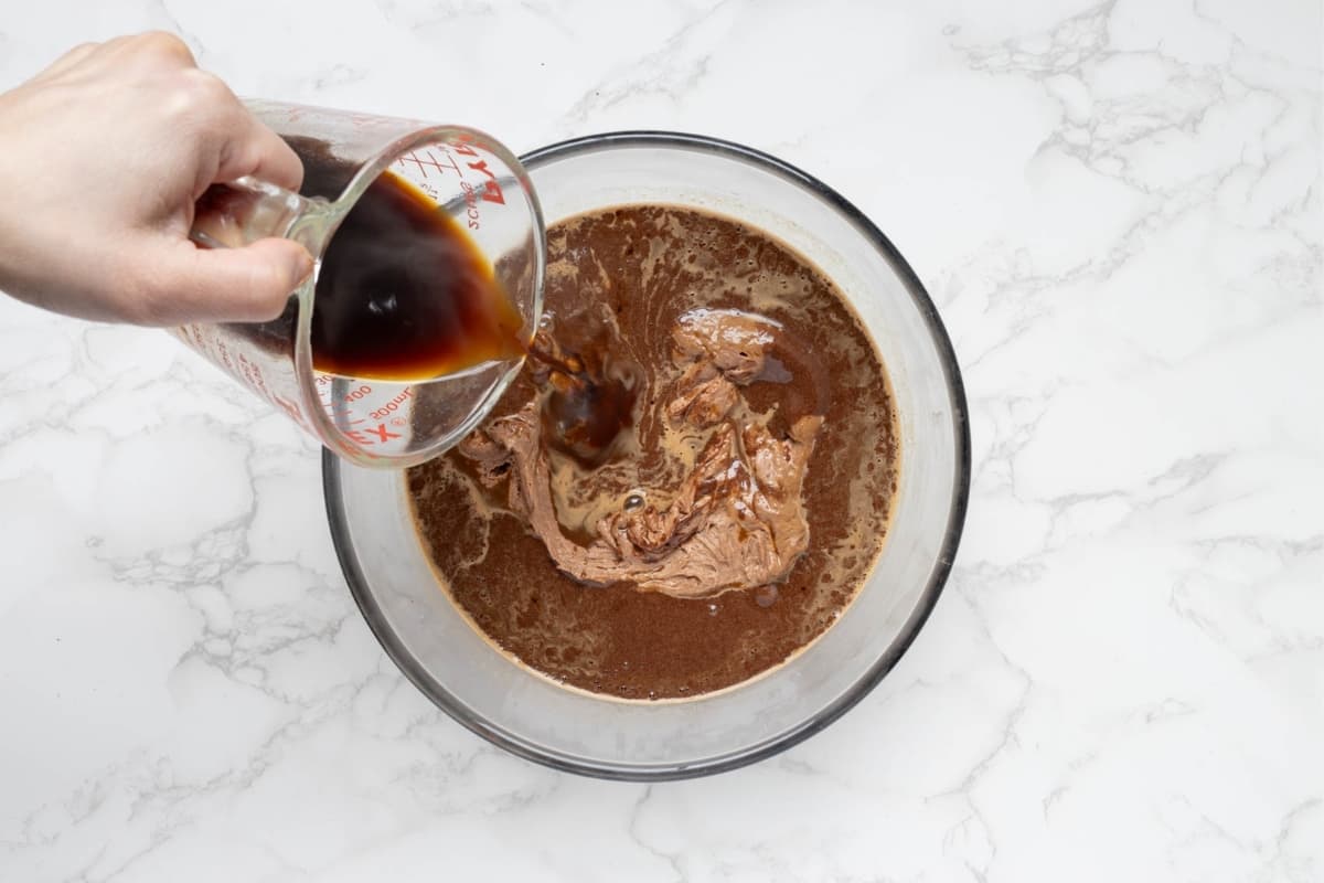 Adding coffee to the chocolate sourdough preferment to make the sourdough chocolate cake batter.