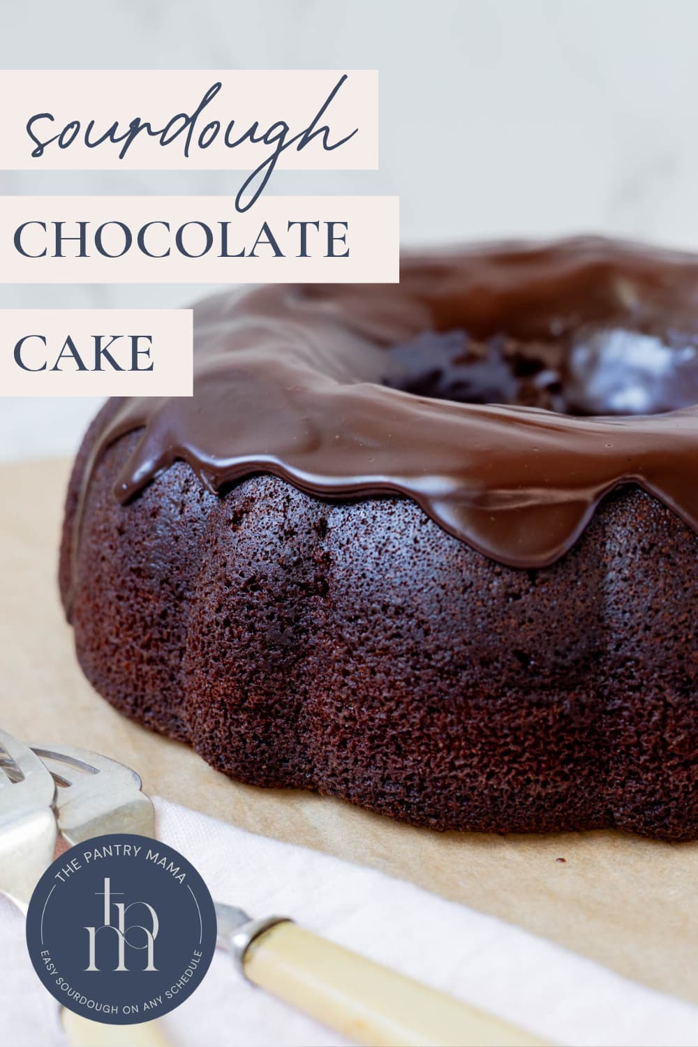 Pinterest graphic featuring a sourdough chocolate bundt cake topped with shiny chocolate ganache and text overlay.