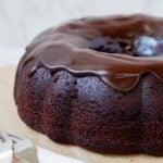 Close up of sourdough chocolate bundt cake topped with glossy chocolate ganache.