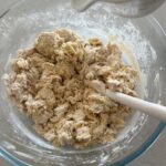 Flour and salt have been mixed into the pumpkin puree mix and formed a shaggy, dry dough