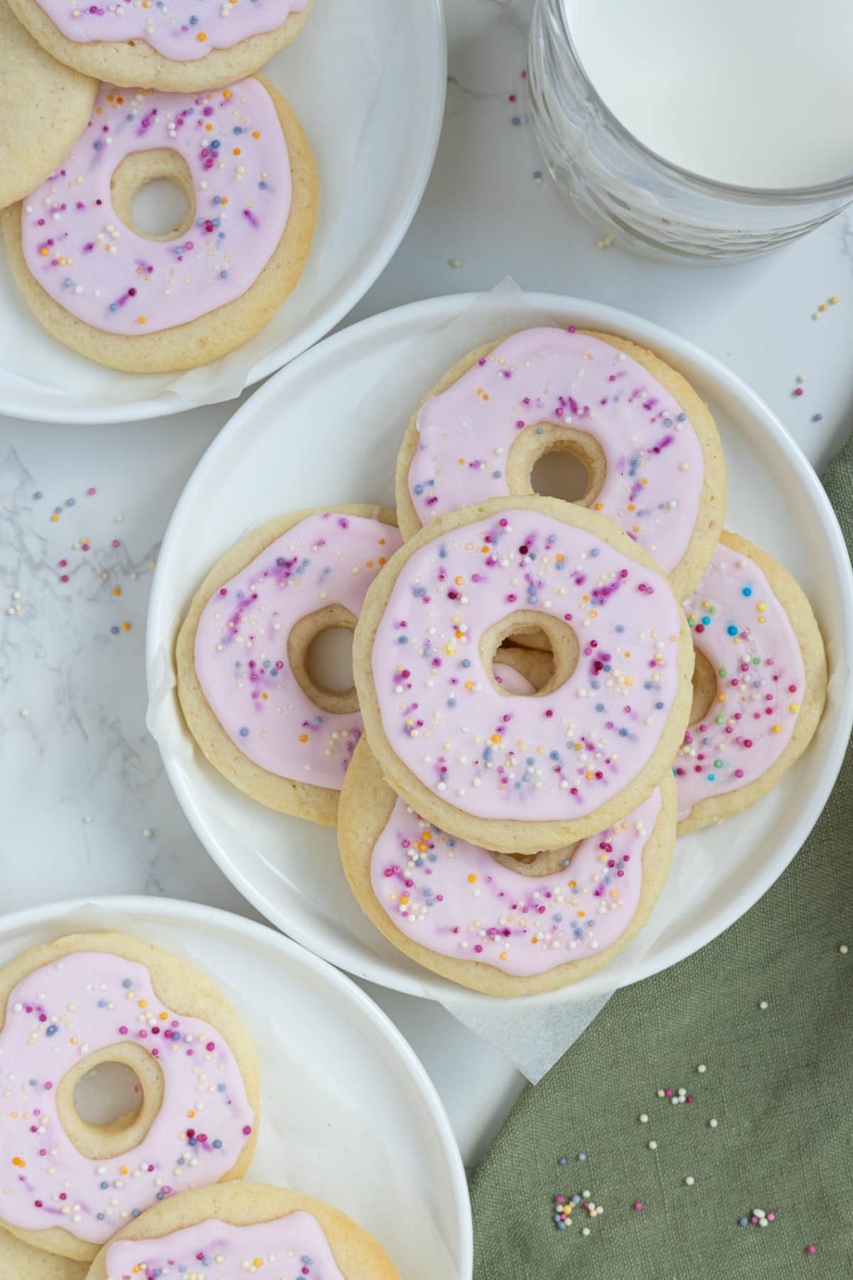 A photo of sourdough sugar cookies that have been decorated to look like little pink donuts.