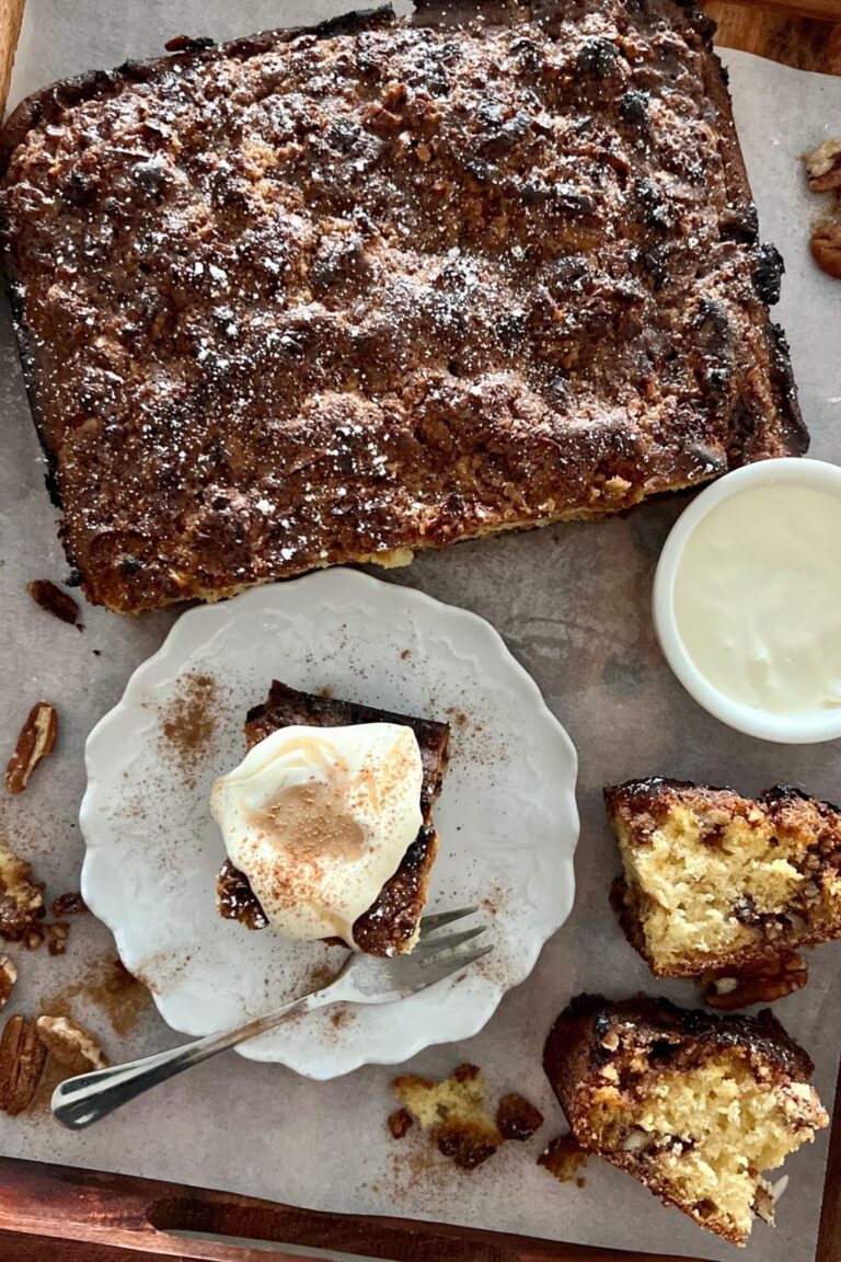 How to add sourdough discard to any recipe - including this cinnamon coffee cake. The coffee cake has been cut up into pieces and is sitting with a bowl of double cream.