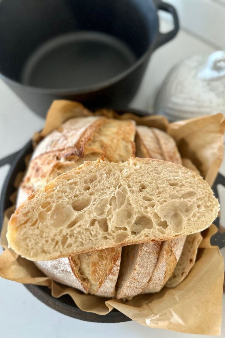 Sourdough Bread made with all purpose flour. There is a slice of all purpose sourdough bread sitting on the top of the whole loaf.