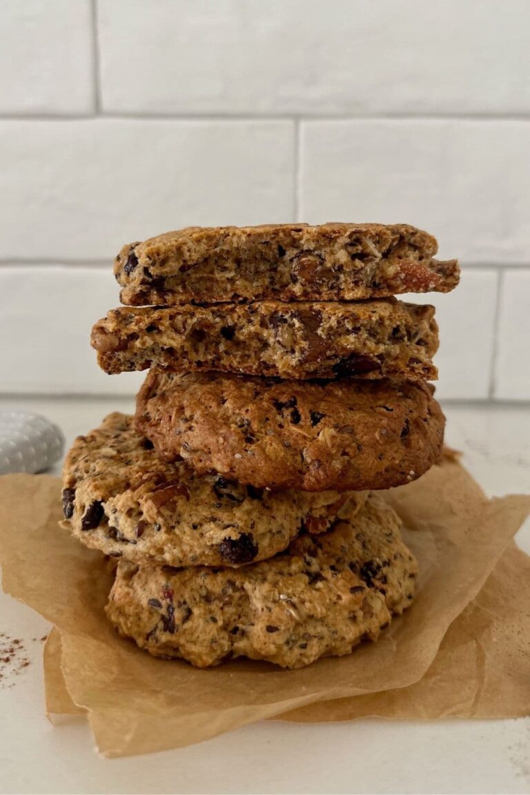 A stack of sourdough breakfast cookies sitting in front of a white tiled wall.