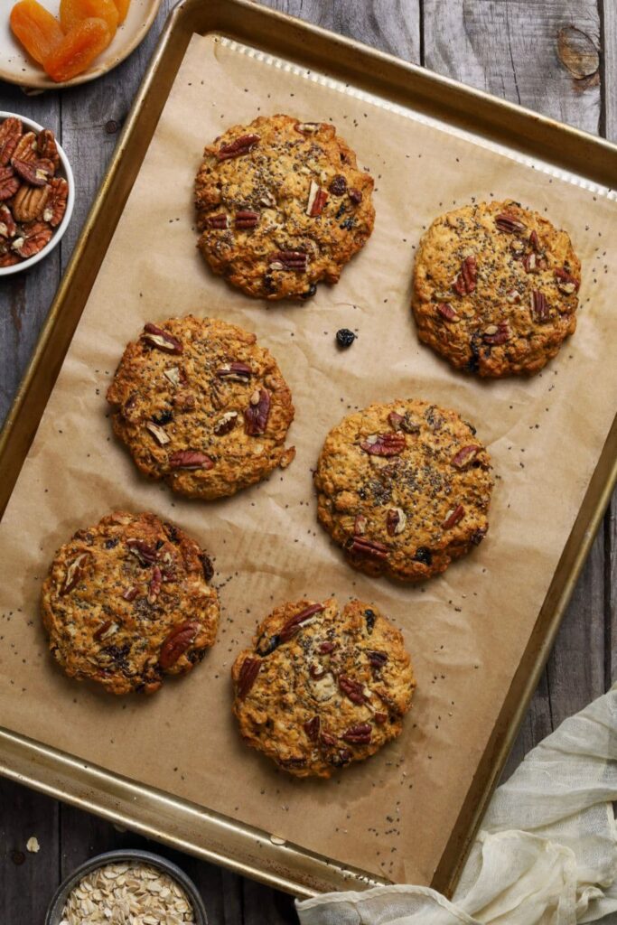Sourdough breakfast cookies cooling on a baking tray lined with baking paper.