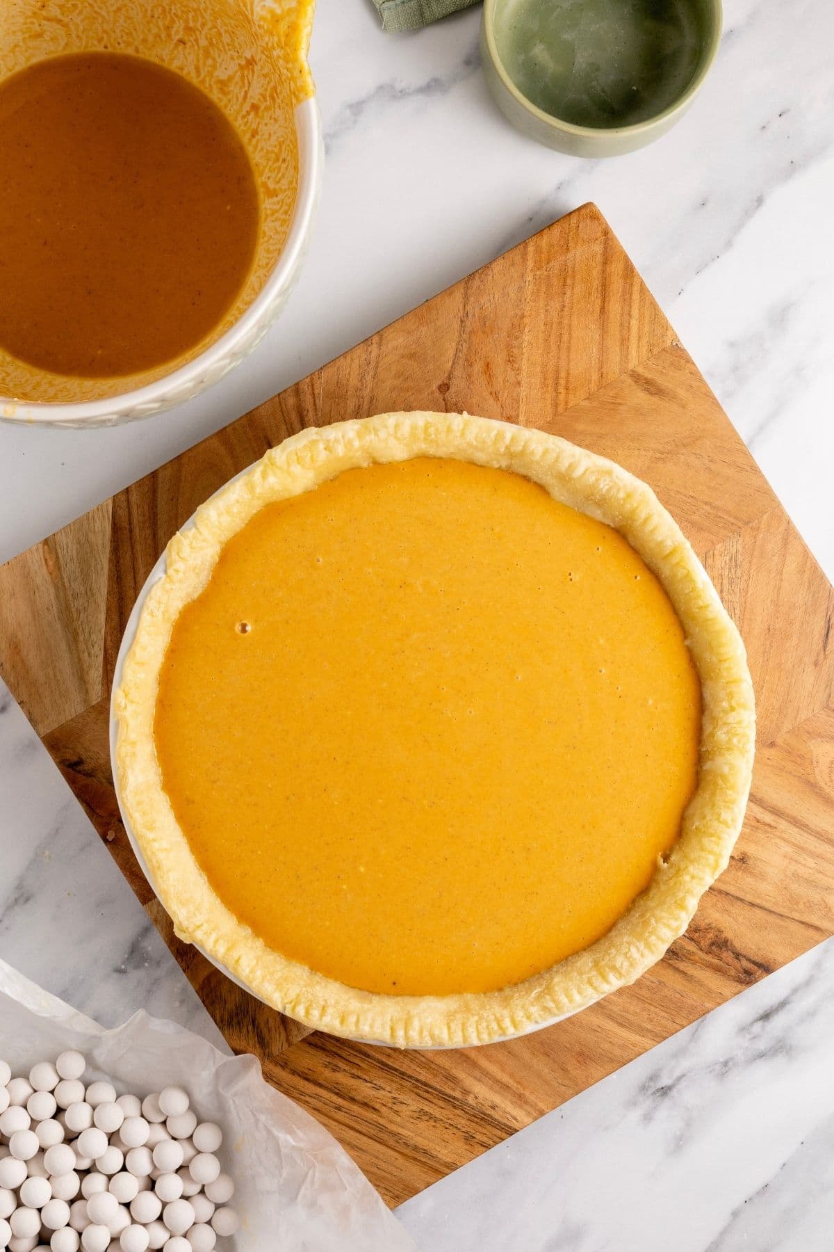 An image taken from above of the pumpkin pie filled and ready to bake.