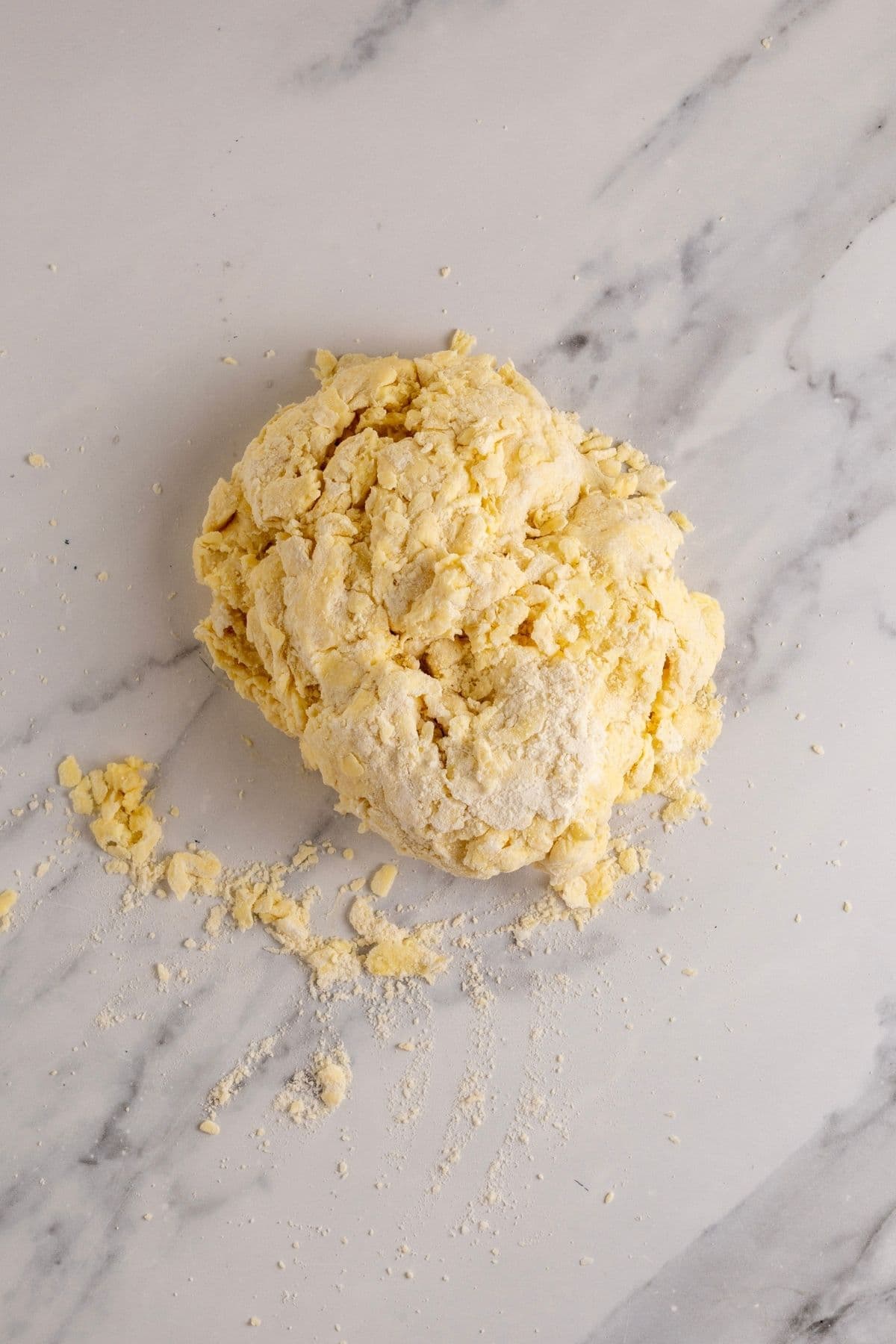 A batch of sourdough pastry formed into a rough dough and tipped out onto the counter.