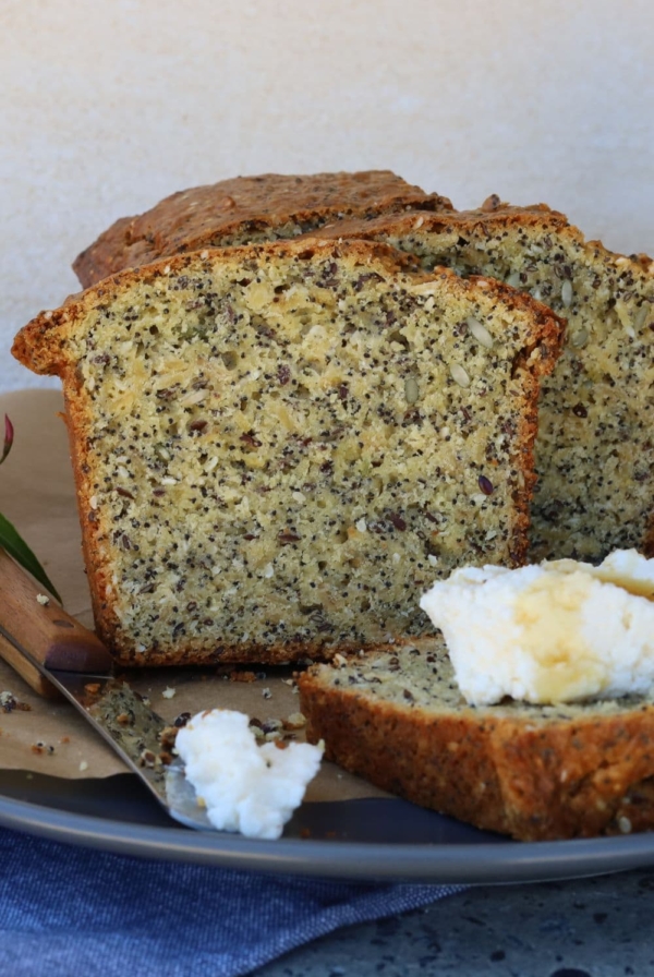 Seedy sourdough breakfast loaf served with whipped ricotta cheese and honey.