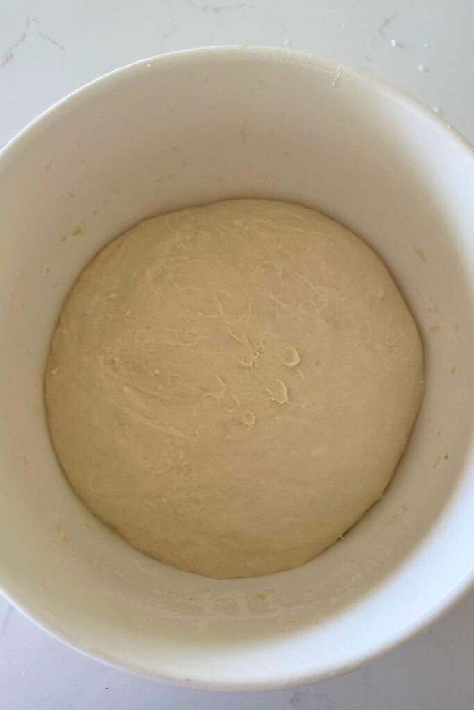 A bowl of sourdough ciabatta dough that has been through bulk fermentation.