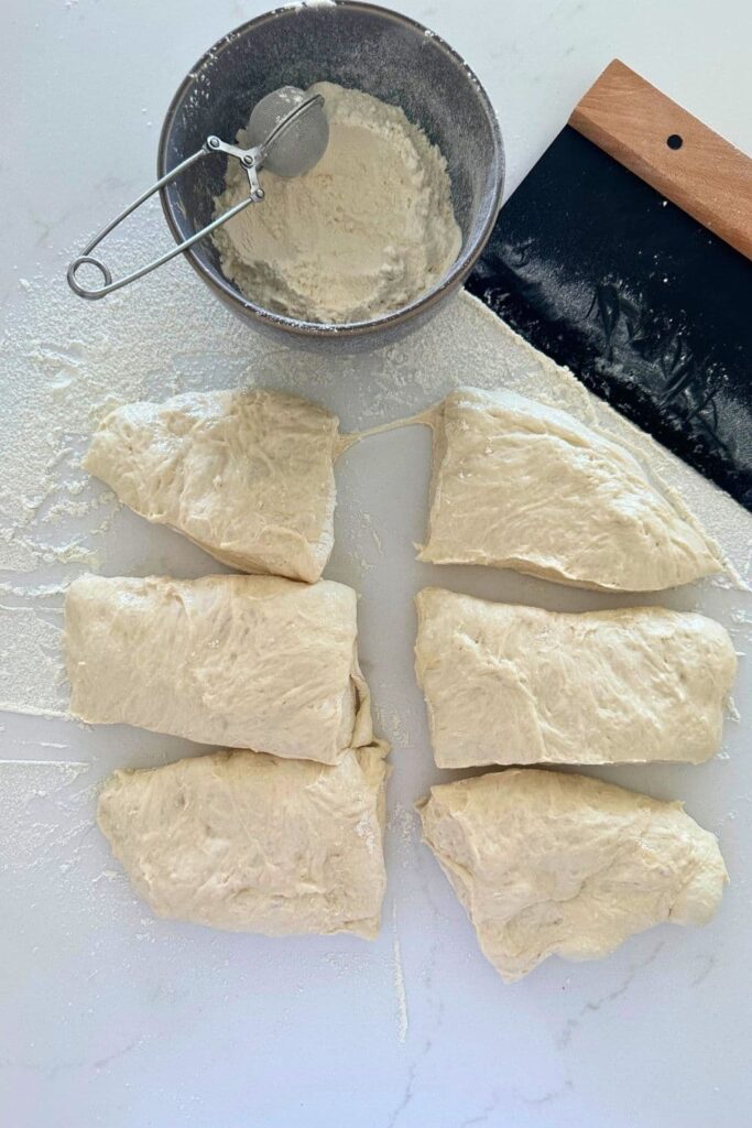 Sourdough ciabatta dough cut into 6 equally weighted pieces ready to be shaped.