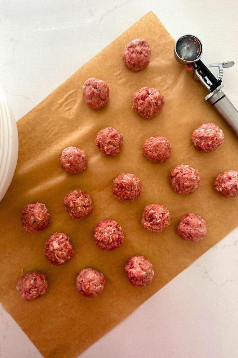 Sourdough meatballs laid out on a piece of parchment paper.