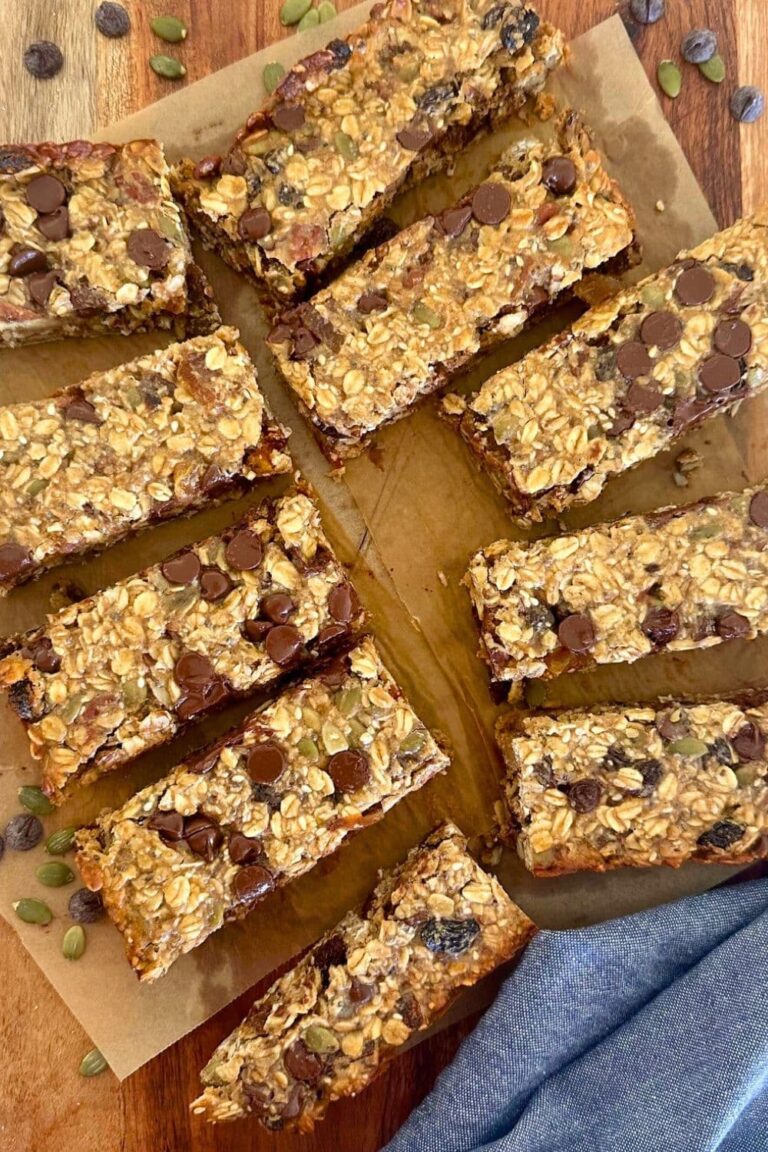 A selection of baked sourdough granola bars displayed on a wooden board.