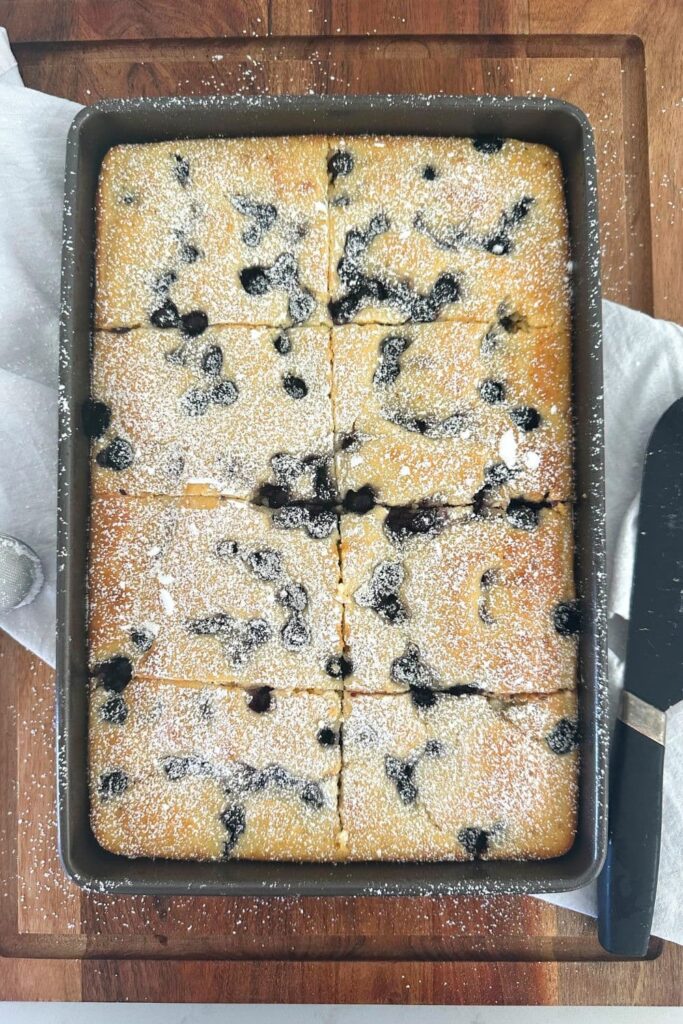 A sheet pan filled with blueberry baked sourdough discard pancakes.