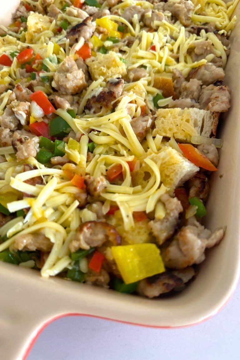 A casserole dish containing sourdough breakfast casserole that is ready to be baked in the oven.