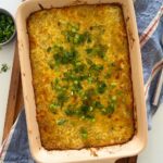 Sourdough hash brown casserole baked in a 9" x 13" baking dish and topped with green onions.