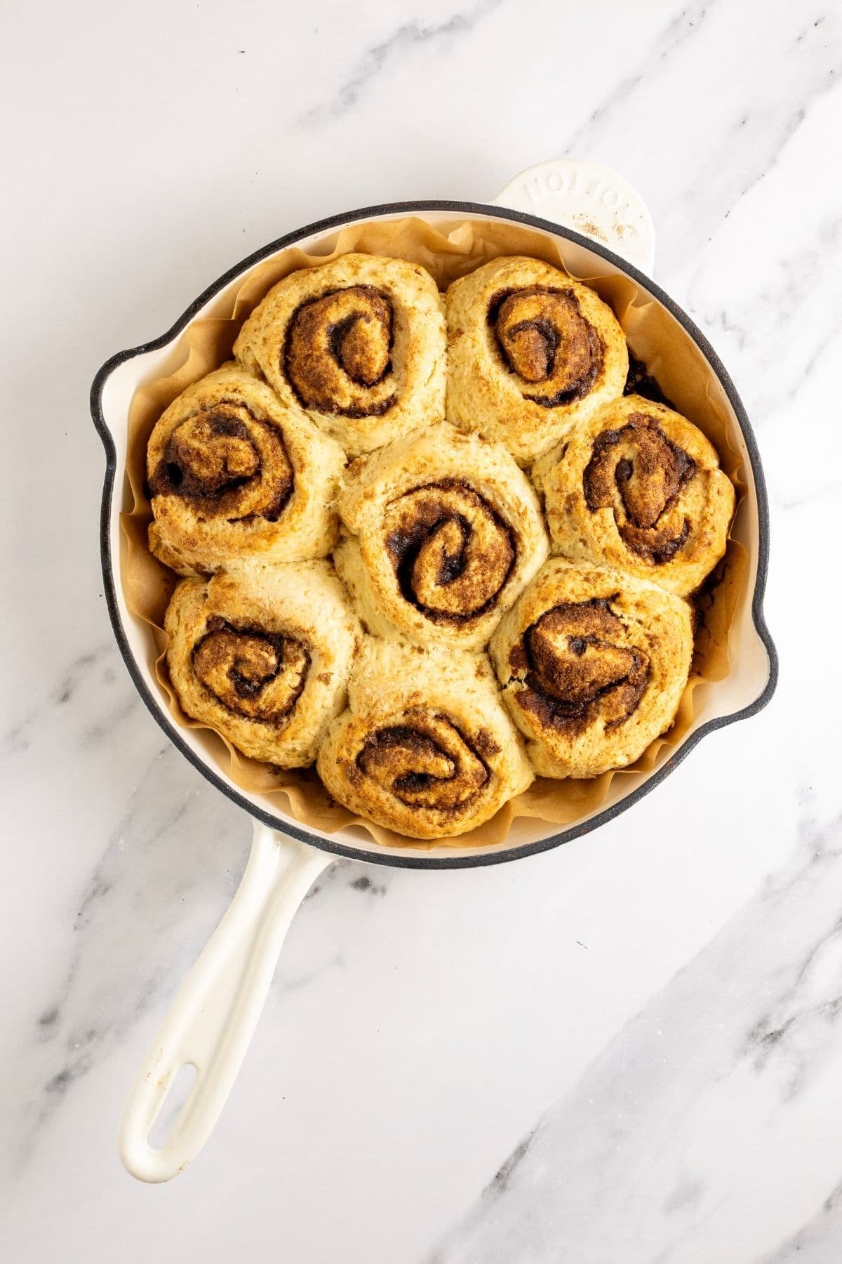 Sourdough discard cinnamon rolls that have been baked until just golden and taken out of the oven.
