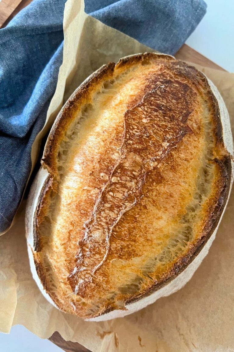 A loaf of sourdough bread with a double ear created by scoring the bread down the middle of the loaf.