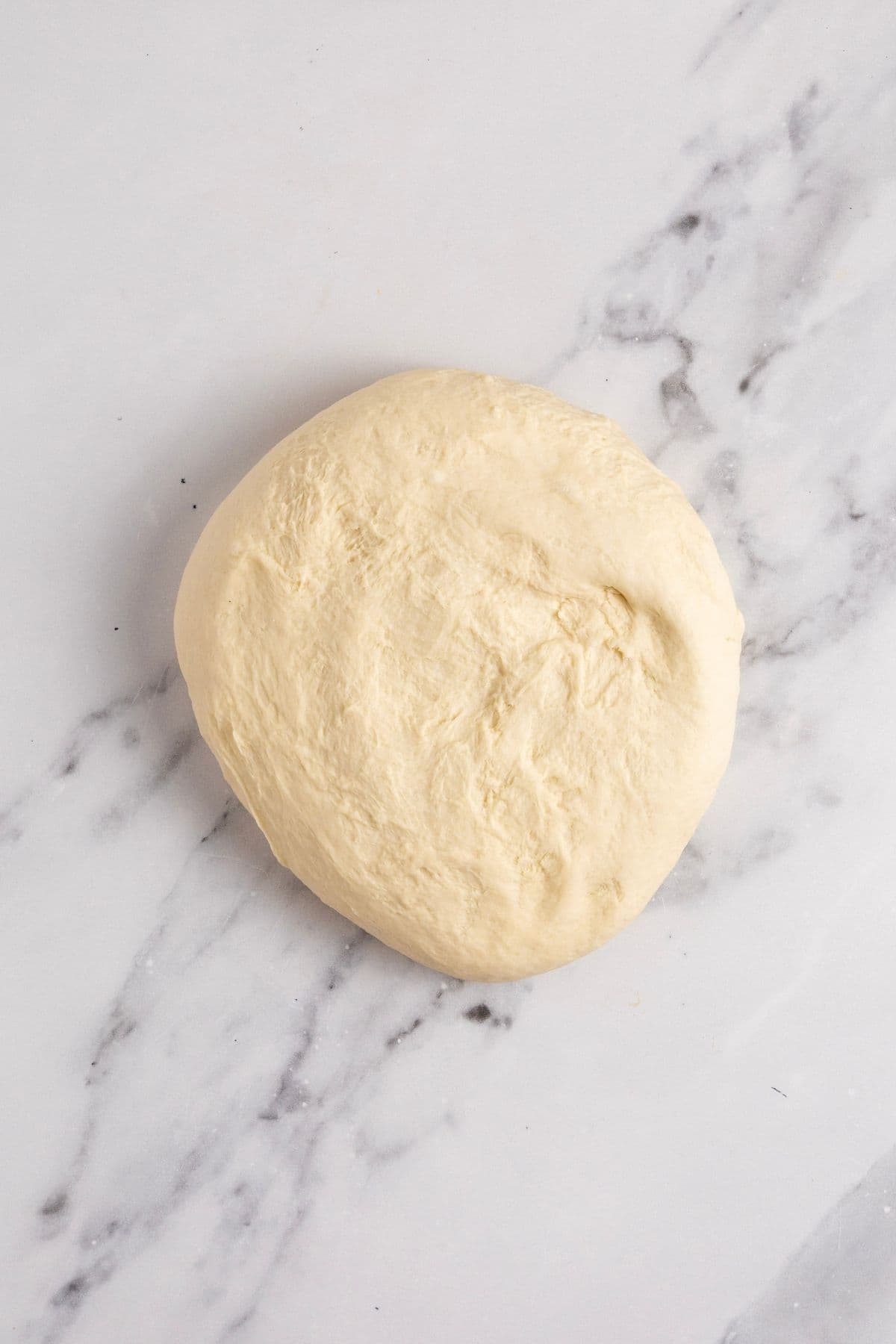 Sourdough discard tortilla dough that has been kneaded and can now be left to rest.