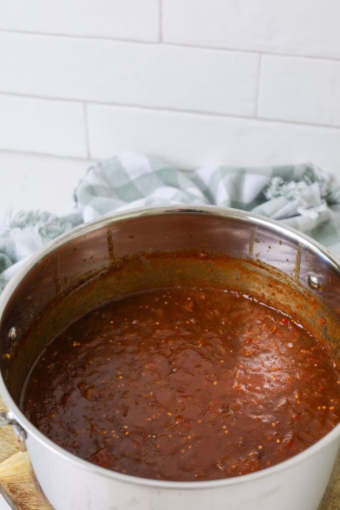 A large stainless steel pot of chilli tomato relish ready to be put into jar.