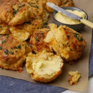 Sourdough cheddar biscuit that has been split open and buttered.