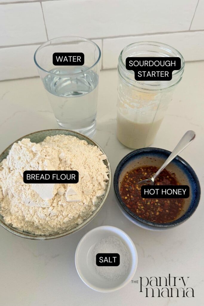 Flat lay of ingredients used to create a loaf of hot honey sourdough bread.