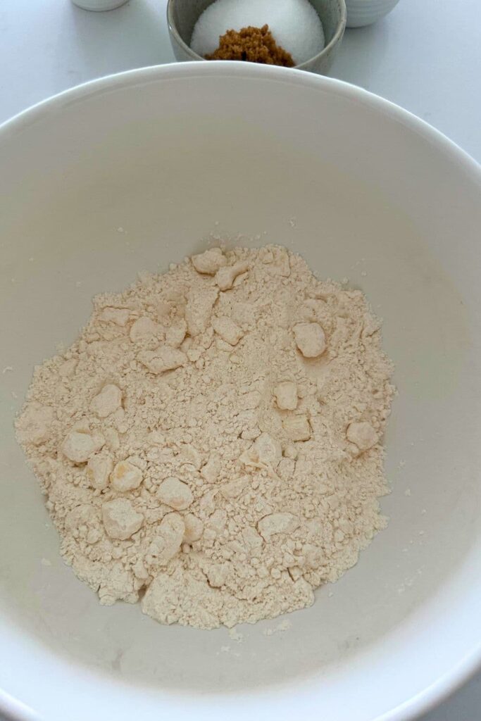 A bowl of flour with butter rubbed into it.