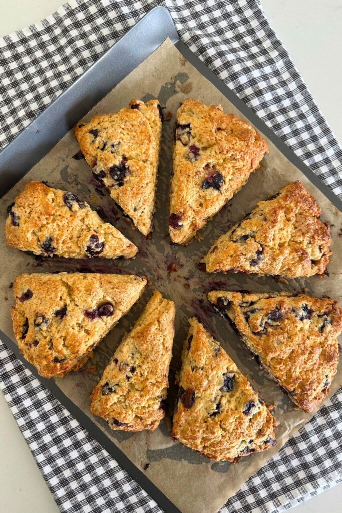 8 wedges of sourdough blueberry scones that have just been taken out of the oven.