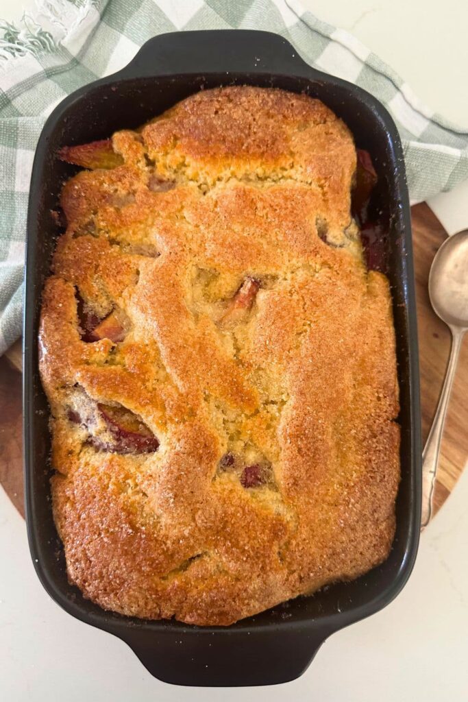 A sourdough peach cobbler that has just been taken out of the oven and set to cool.