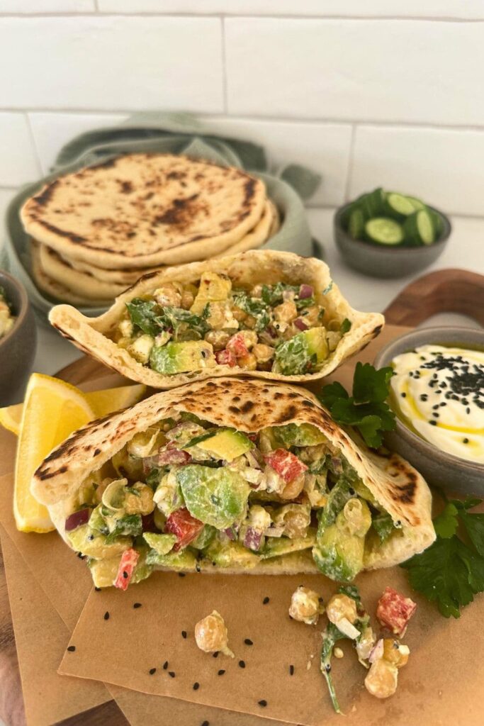 A sourdough pita bread that has been filled with salads.