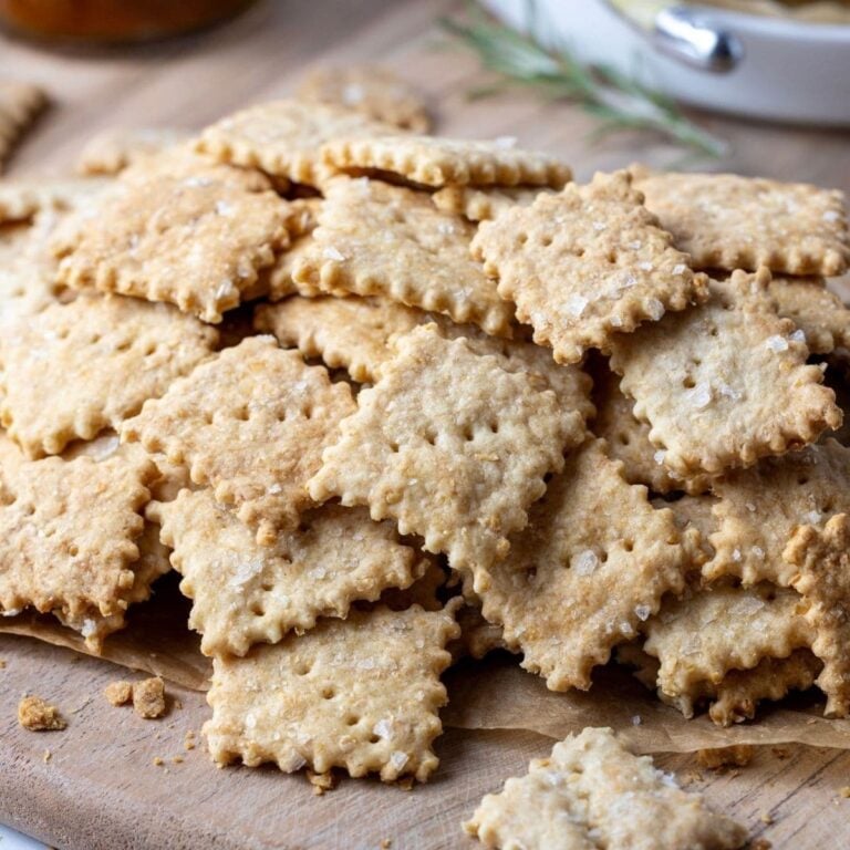 A generous stack of whole wheat sourdough crackers with frilly edges.