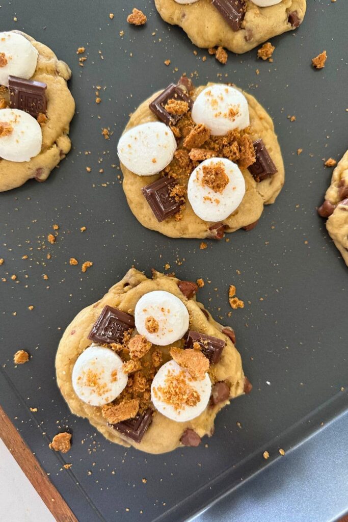 A close up photo of the par baked s'mores cookies after the toppings have been added and before they are about to go back into the oven to melt the marshmallows.